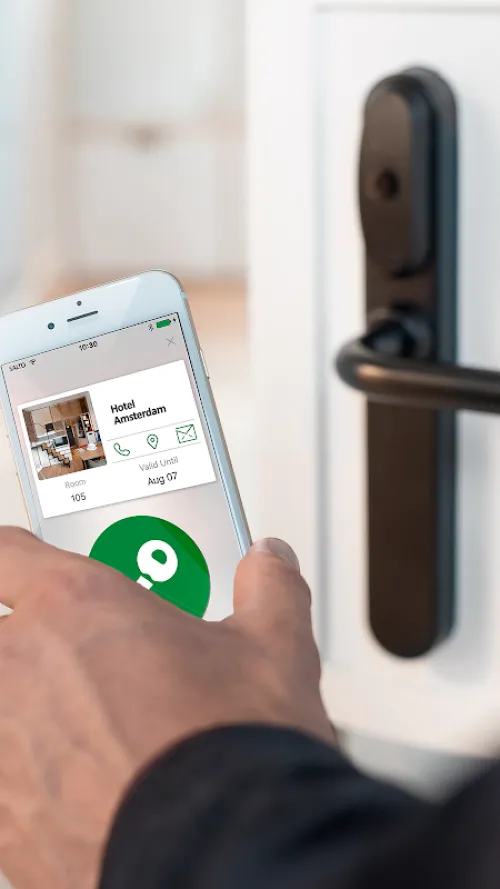 Guest holding a smartphone with the JustIN app up to a door to open it